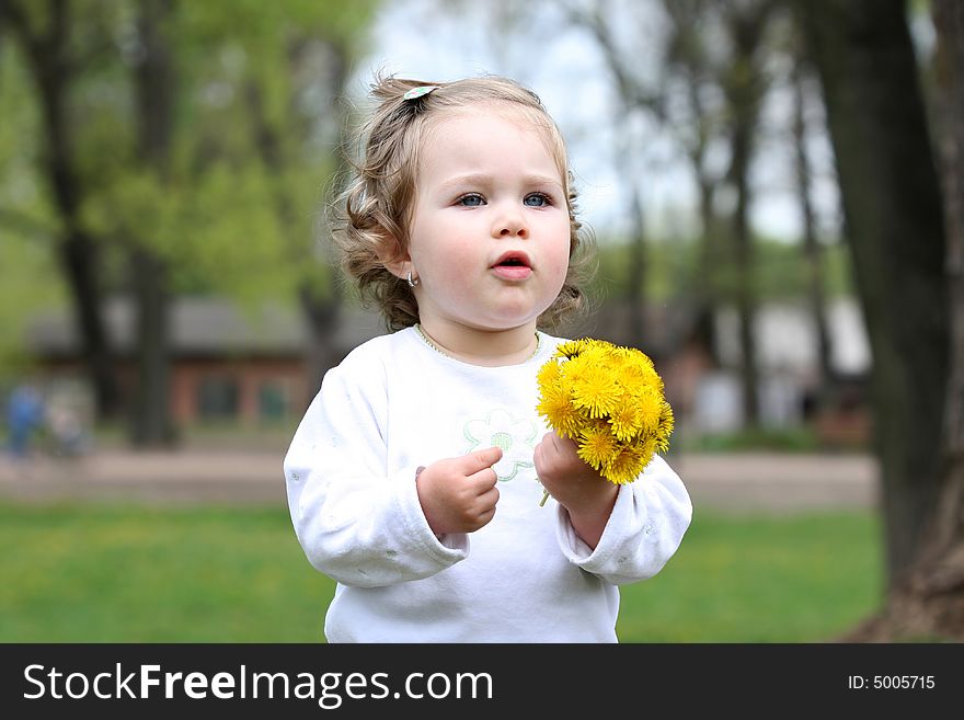 Beautiful pretty girl with flower in the park
