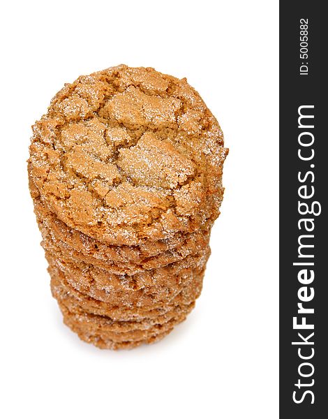 Stack of chewy ginger cookies over white.