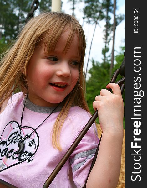 Beautiful four year old child on the swing. Beautiful four year old child on the swing