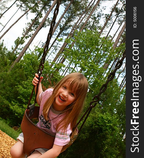 Beautiful four year old child on the swing. Beautiful four year old child on the swing