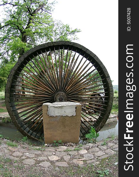 A large water wood mill wheel. A large water wood mill wheel