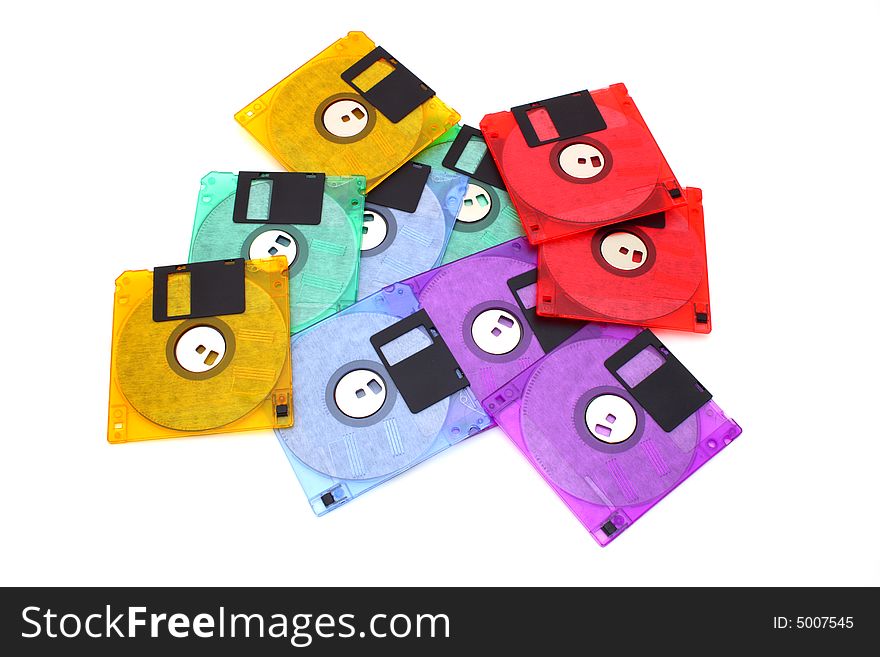 Several floppy disks of different colors scattered over a white surface. Several floppy disks of different colors scattered over a white surface