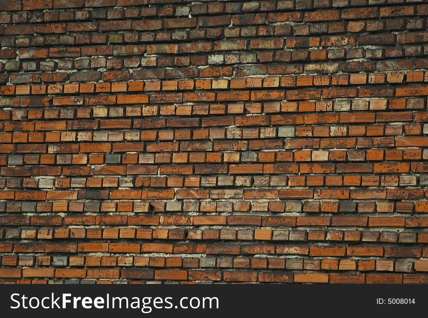 Brick wall made from yellow and grey bricks