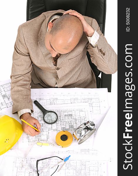 Businessman thinking with architectural plans on white background