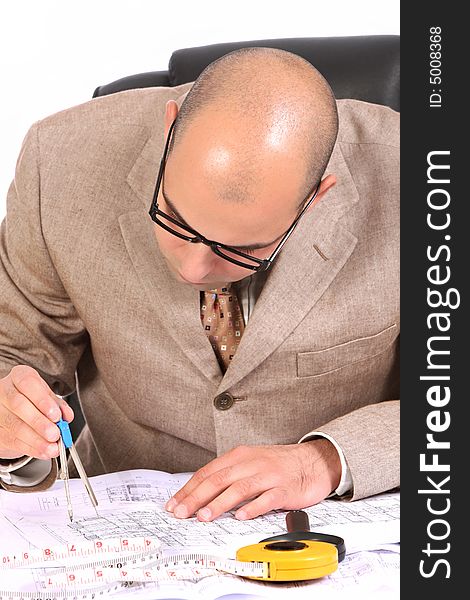 A Businessman working with architectural plans. A Businessman working with architectural plans