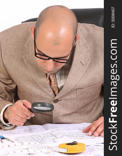 A Businessman working with architectural plans. A Businessman working with architectural plans