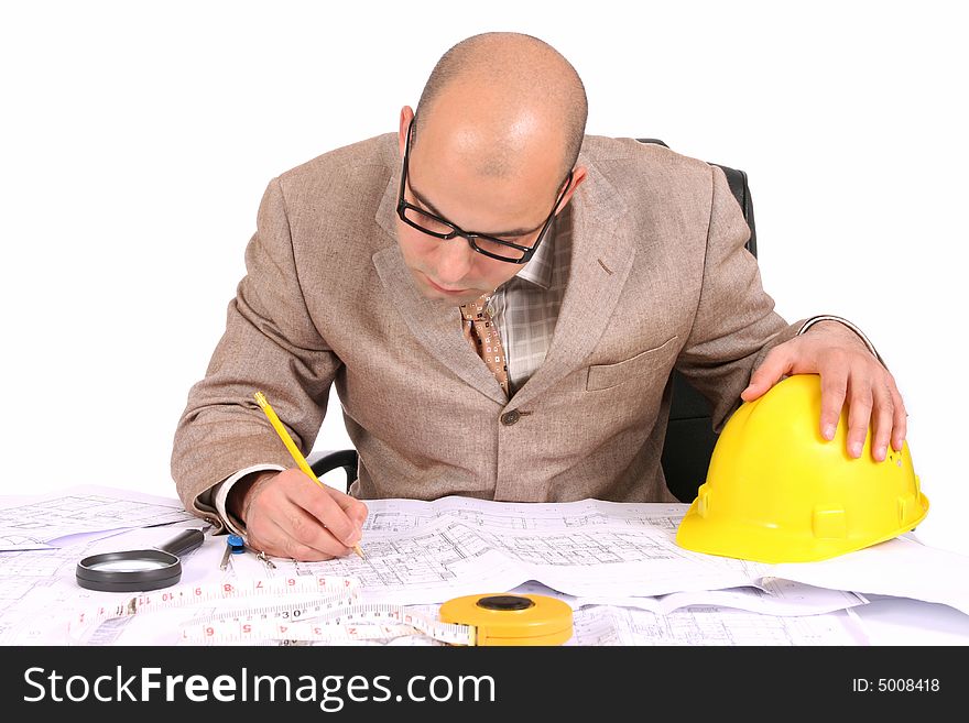 A Businessman working with architectural plans. A Businessman working with architectural plans