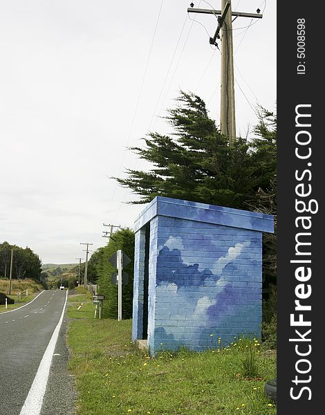 A brightly painted bus stop shelter in the country. A brightly painted bus stop shelter in the country