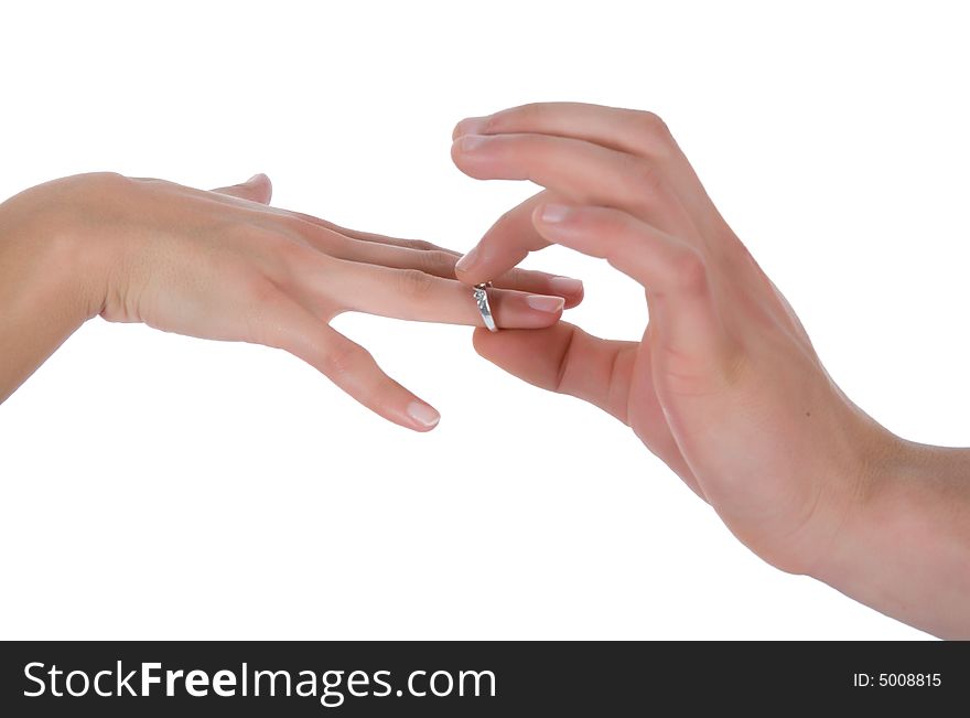 Man's and female hands with a wedding ring on the white