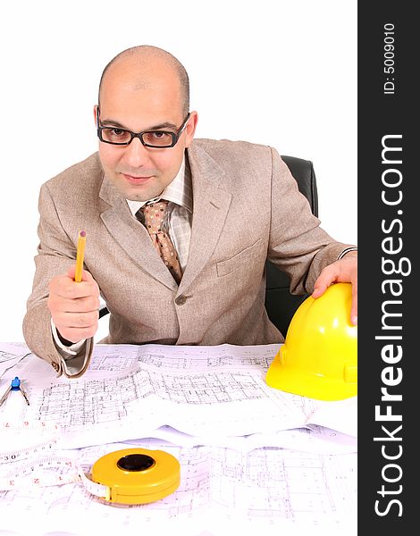 A businessman happiness with architectural plans at desk