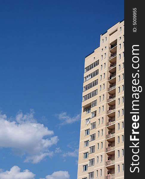 Inhabited multi-storey building on a background of the dark blue sky and clouds. Inhabited multi-storey building on a background of the dark blue sky and clouds