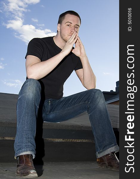 Portrait of a handsome young man on the roof. Portrait of a handsome young man on the roof