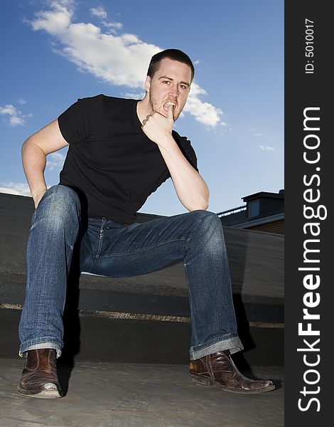 Portrait of a handsome young man on the roof. Portrait of a handsome young man on the roof