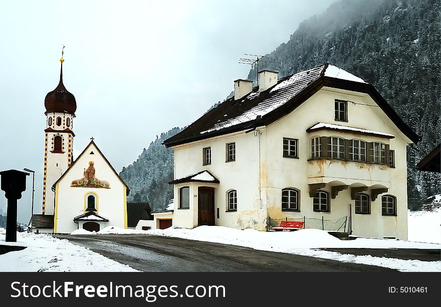 Houses And Church In The Alps