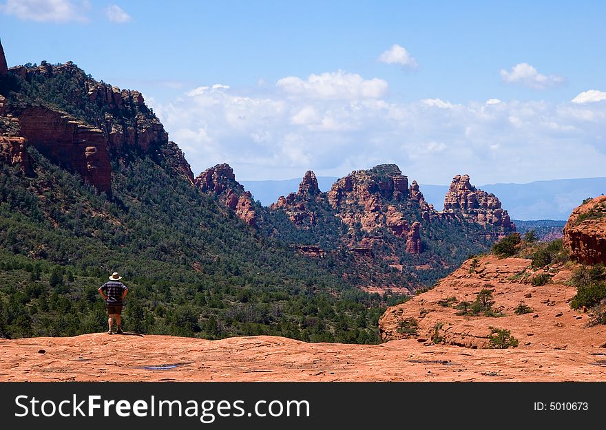 Rear shot of single hiker overlooking the red rock in Sedona. Rear shot of single hiker overlooking the red rock in Sedona