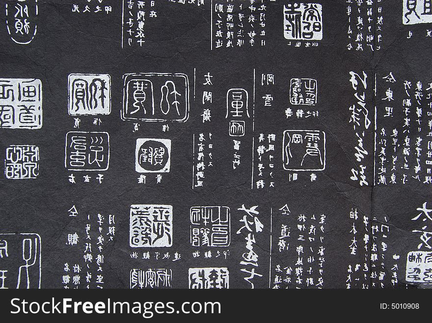 Close-up wiht the rough paper decorated with hieroglyph-like signs