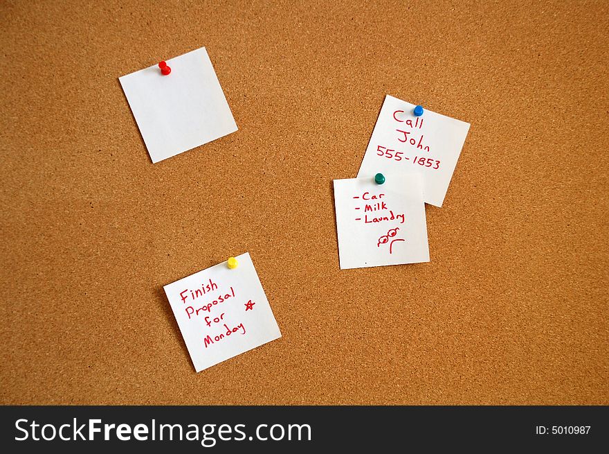 Cork board with a note pinned to it. Cork board with a note pinned to it