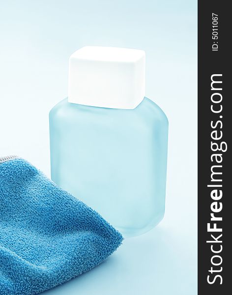 Lotion and blue face cloth. Lotion and blue face cloth