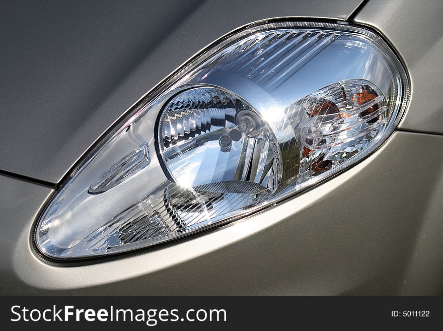 Close - up of car headlight. Close - up of car headlight.