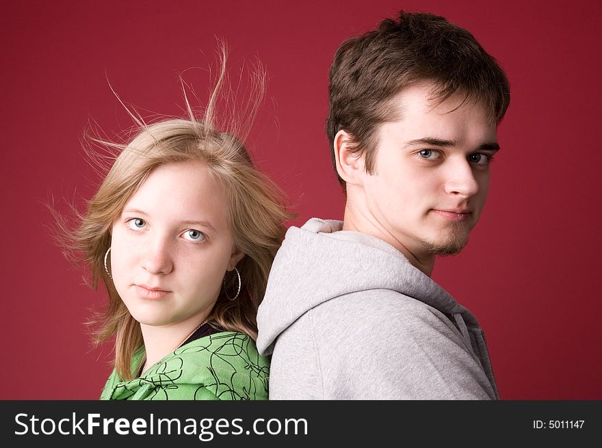 The young girl and the guy on a red background. The young girl and the guy on a red background.