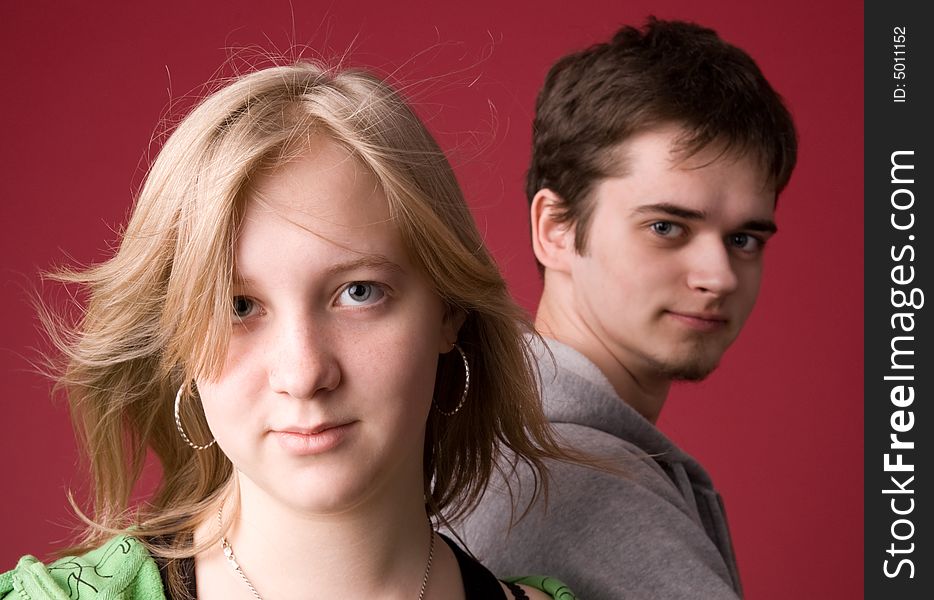 The young girl and the guy on a red background. The young girl and the guy on a red background.