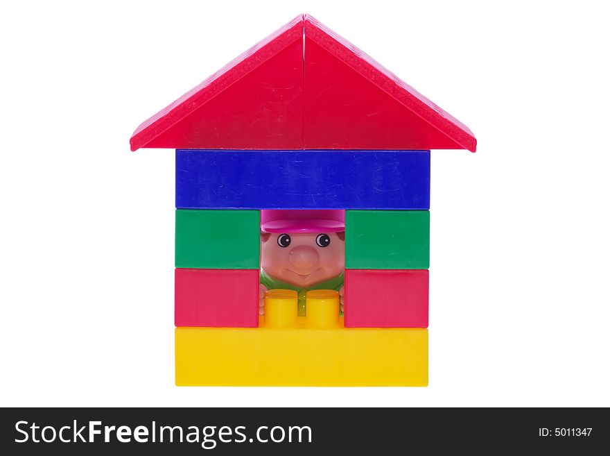 House made of blocks with toy man looking through te window. House made of blocks with toy man looking through te window