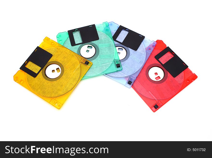 Four colorful floppy disks over a white surface