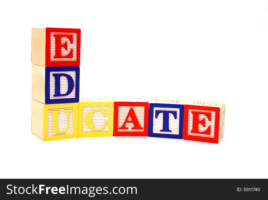 Word educate formed by letter wood blocks over a white surface