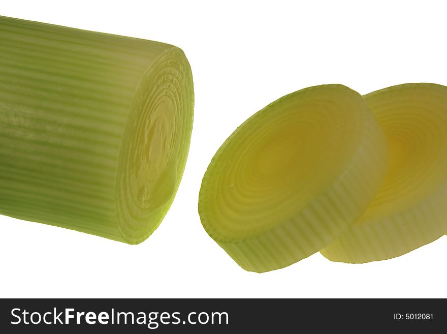 Green leek with two slices against white background. Green leek with two slices against white background
