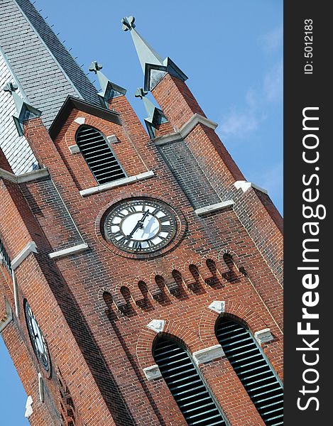 A clock tower belonging to a church. A clock tower belonging to a church.