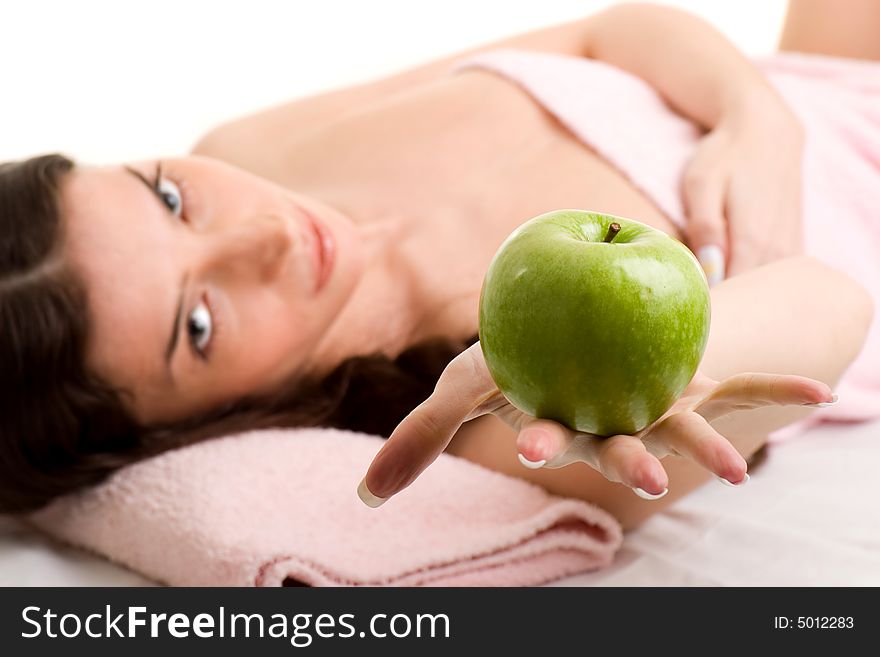 Beautiful young woman in towel holding green apple. Beautiful young woman in towel holding green apple