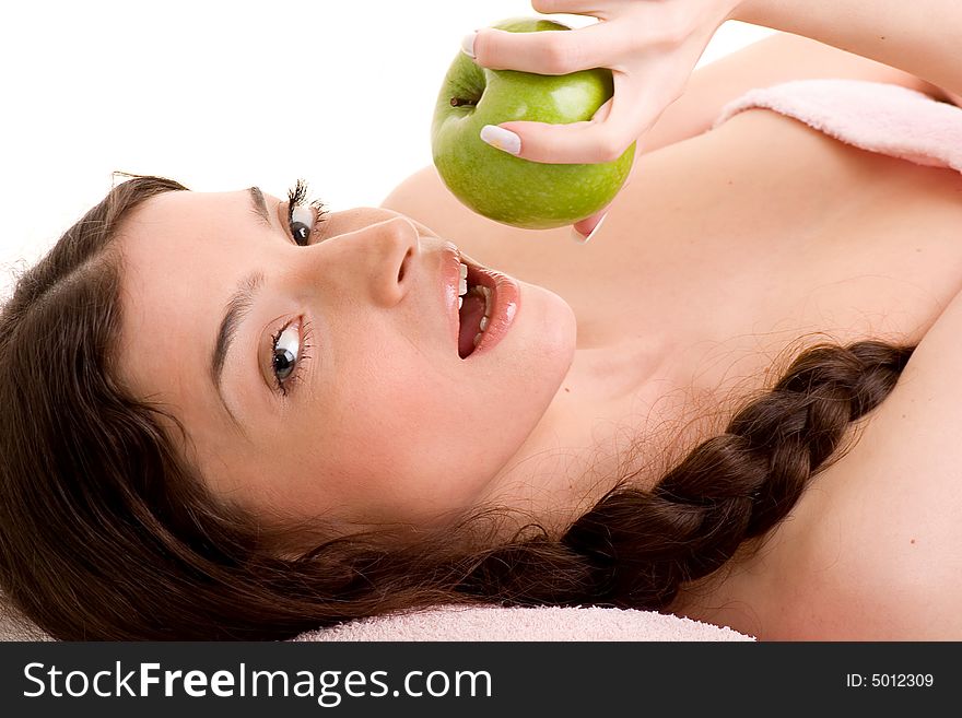 Beautiful young woman in towel holding green apple. Beautiful young woman in towel holding green apple