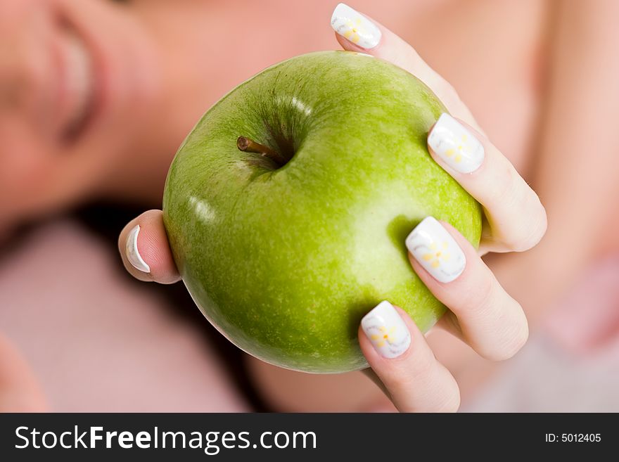 Young woman offering green apple. Young woman offering green apple