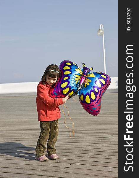 Little girl playing with balloons