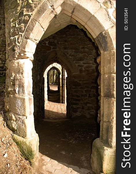 Photo of an old stone doorway leading to the entrance of a castle