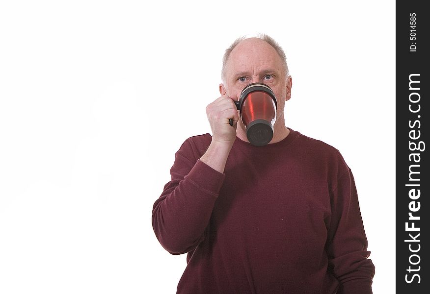 An older guy drinking coffee from a travel mug. An older guy drinking coffee from a travel mug
