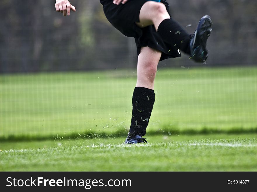 A powerful soccer kick kicks up a lot of turf!. A powerful soccer kick kicks up a lot of turf!