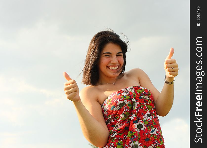 Woman displaying a thumbs up gesturep. Woman displaying a thumbs up gesturep