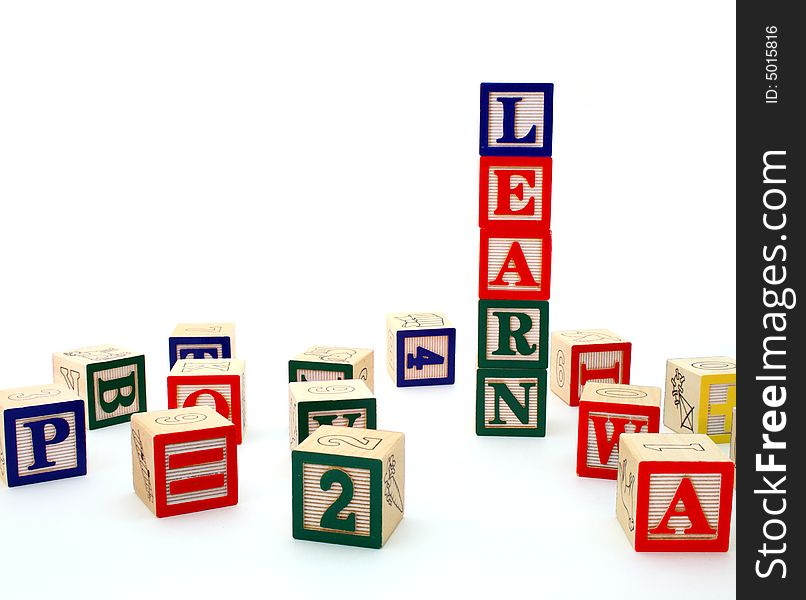 Word learn formed by letter wood blocks over a white surface. Word learn formed by letter wood blocks over a white surface