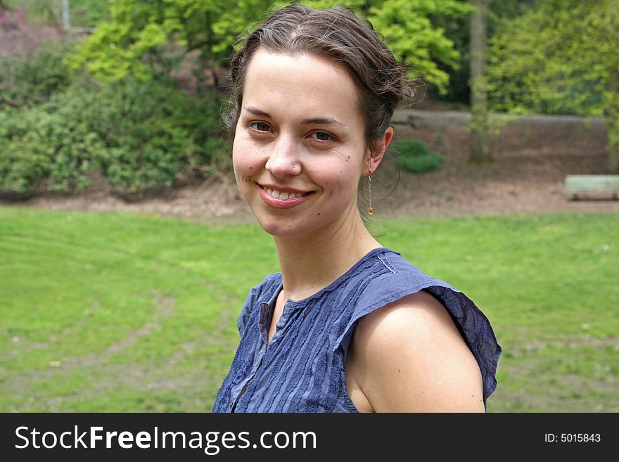 A young woman in a green park on a sunny afternoon. A young woman in a green park on a sunny afternoon.