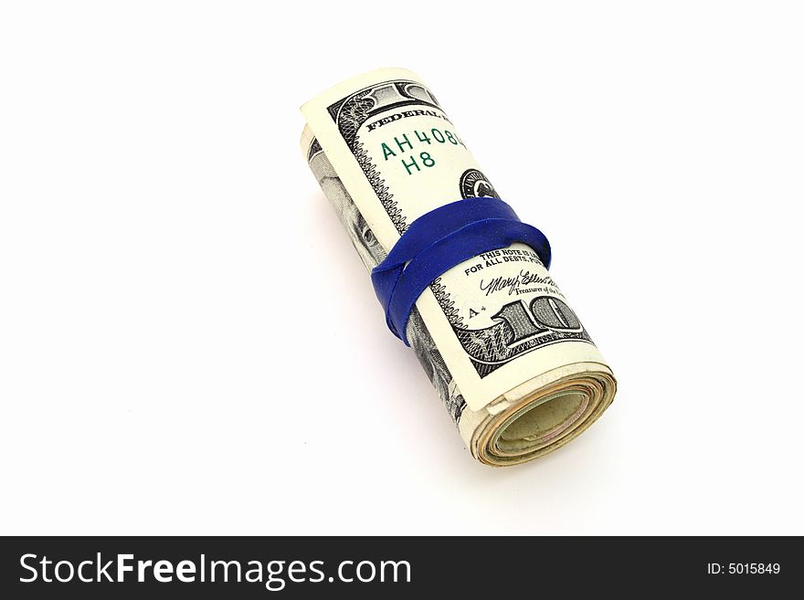 Roll of dollar bills over a white surface. Roll of dollar bills over a white surface