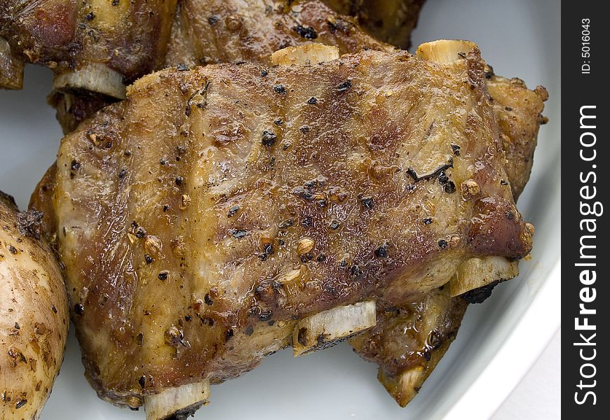 Grilled spare ribs of pork on a white plate