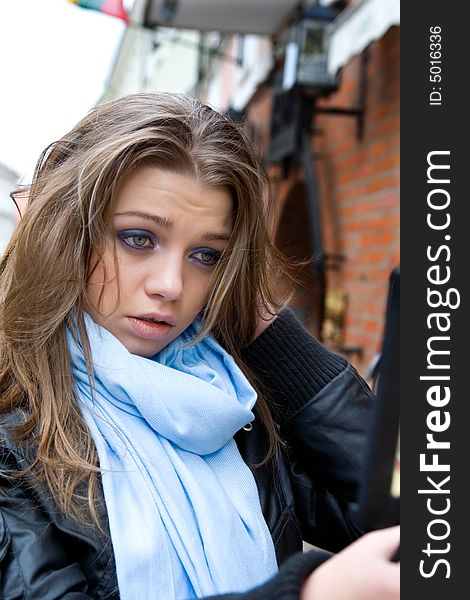 Portrait of the young girl with a blue scarf