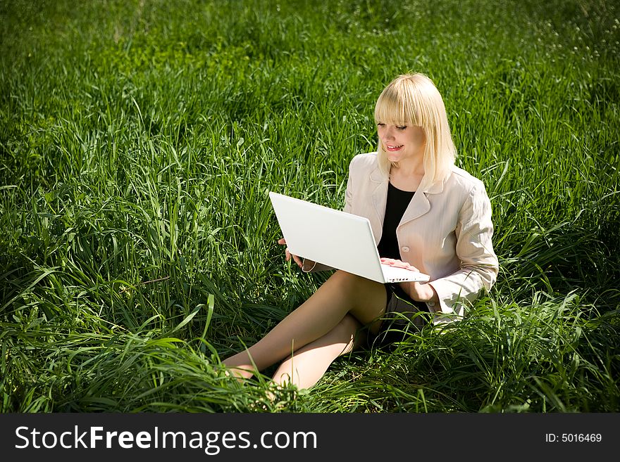 Pretty girl with notebook on the grass. Pretty girl with notebook on the grass