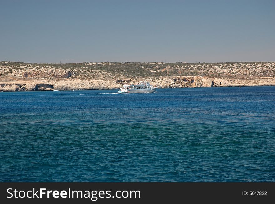 Boat on Mediterranean sea at Cape Greko, sunny day of Cyprus. Boat on Mediterranean sea at Cape Greko, sunny day of Cyprus.