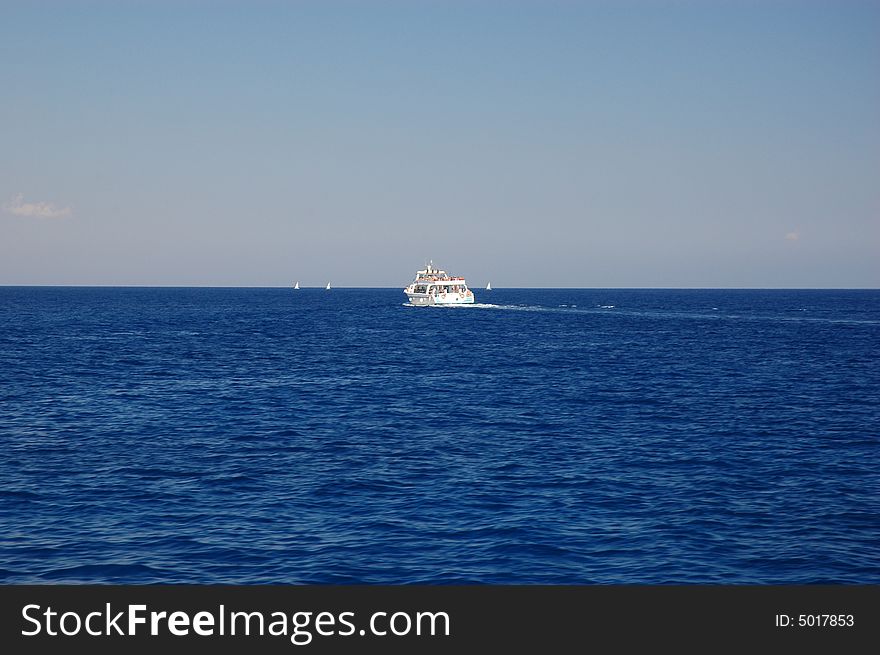 Boat on Mediterranean sea at Cape Greko, sunny day of Cyprus.