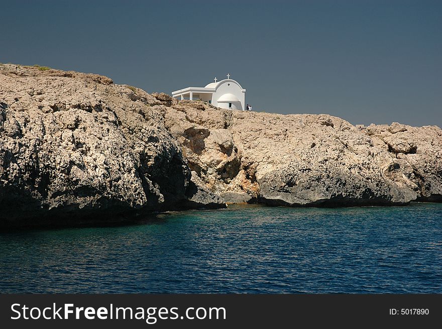 Greek church on Cliffs and the Mediterranean sea. Greek church on Cliffs and the Mediterranean sea