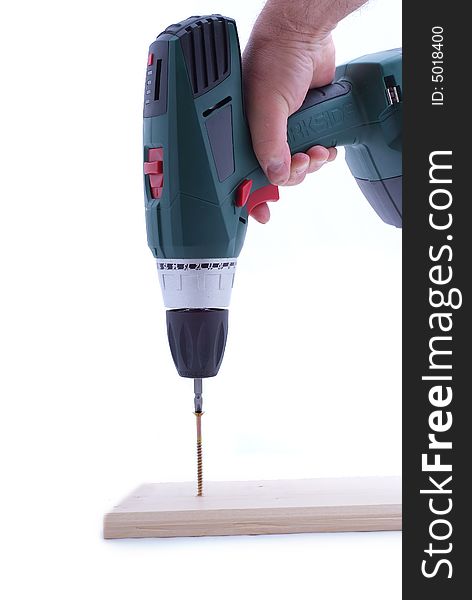 Electric drill on white background in hand of worker