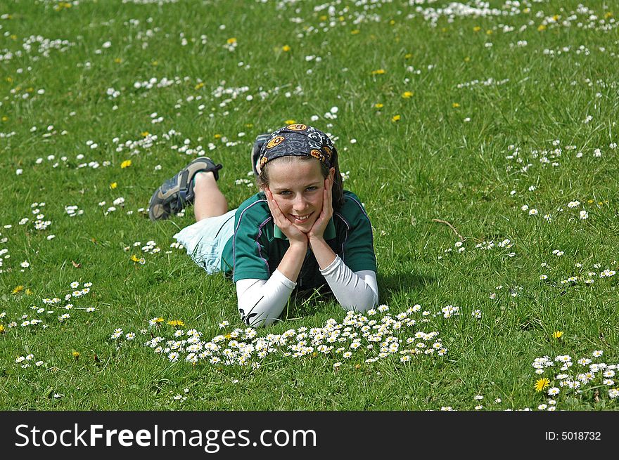 Young girl lying in grass in springtime