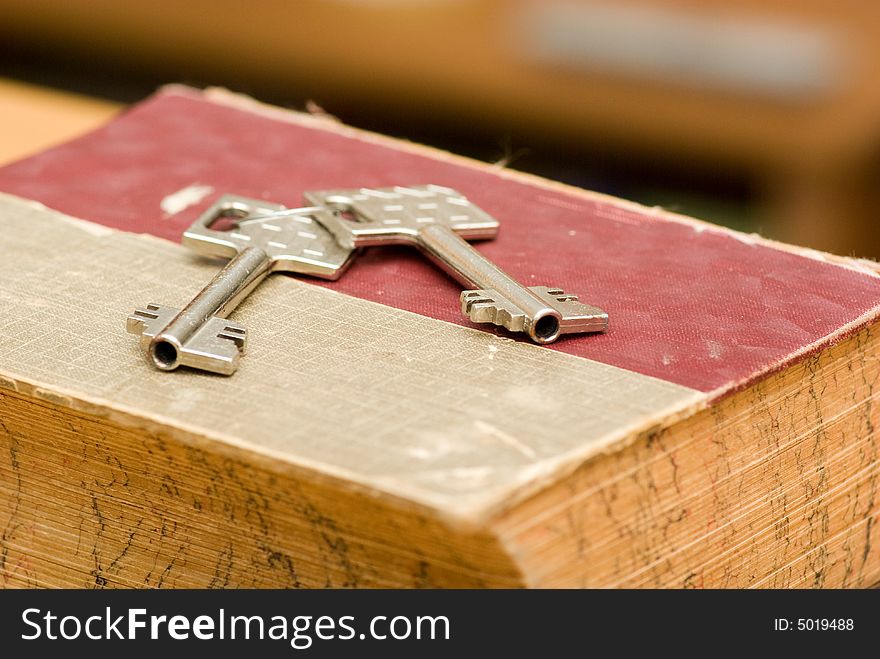 Still life key from safe deposit box and old book